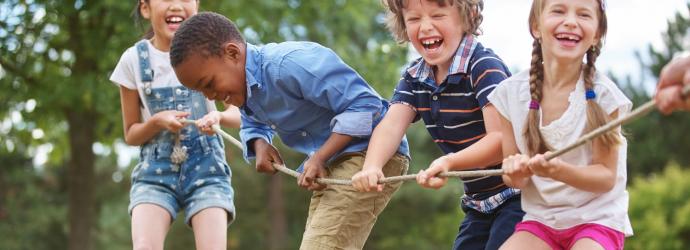 children playing tug-of-war with rope