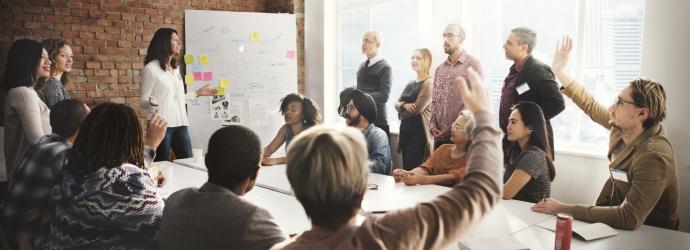 group of people standing in a boardroom