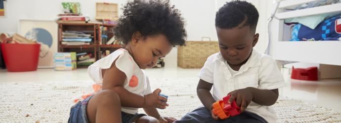 two young boys playing with wooden toys