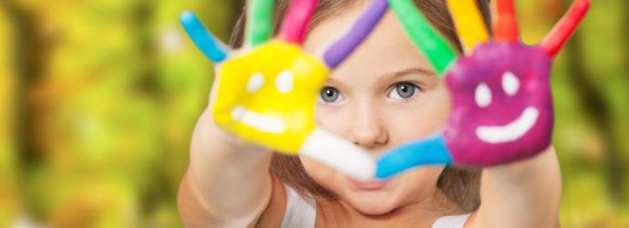 close up of child with painted hands