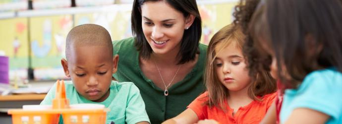 teacher with children at table