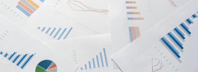 Paper work with charts and graphs to represent a report