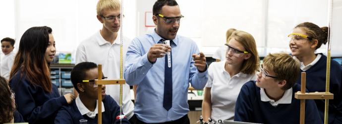 chemistry teacher in a classroom with pupils