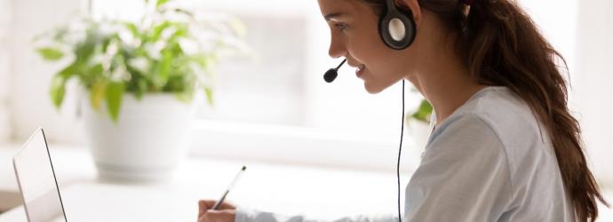 woman at a laptop wearing headset