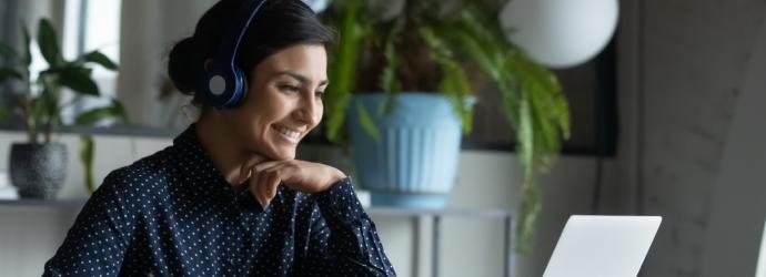 woman sitting a desk smiling