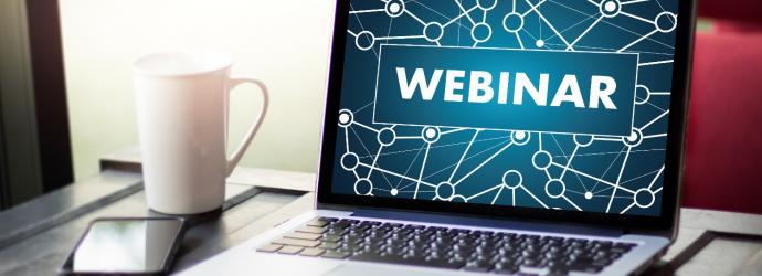 laptop with the word webinar on screen