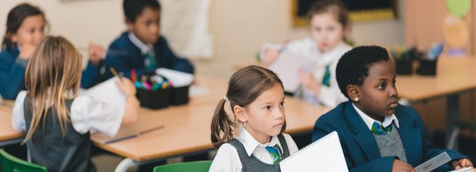 Image shows a group of primary school children in a classroom