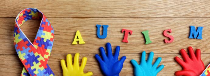 Colourful ribbon with AUTISM spelt above the ribbon
