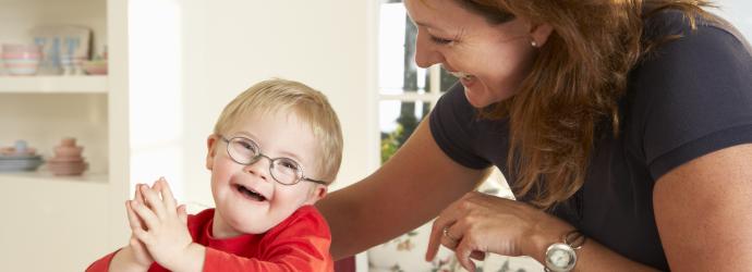 Key worker with a young boy that has Downs Syndrome
