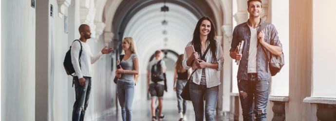 a stylised image of two young students walking in a corridor of an higher education or further education building