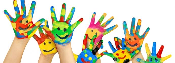 Children's hands painted with colourful faces