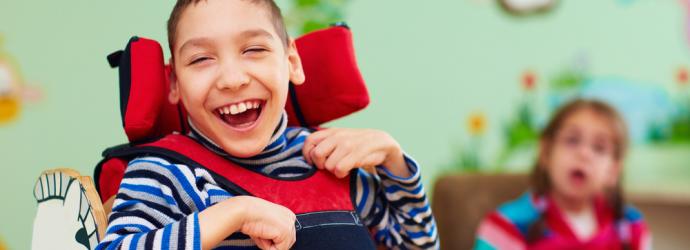 Young boy in wheelchair with SEND in a classroom setting