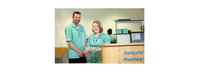 Image shows two healthcare practitioners at work