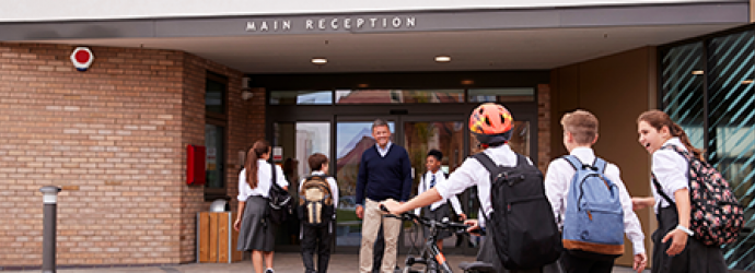 A group of children walking into a school
