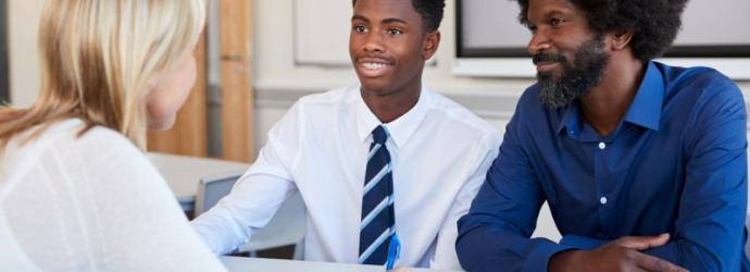 Secondary pupil with parent and teacher
