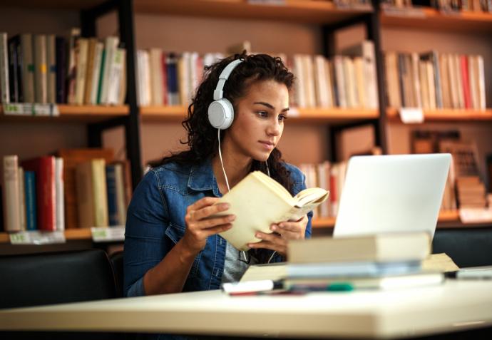 Woman in front of a laptop taking part in a online training session