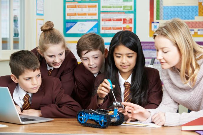 group of students in a STEM lesson with teacher - secondary age