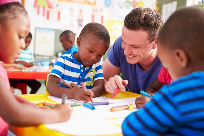 teacher with children drawing pictures
