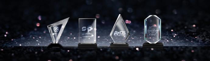 Line up of 4 nasen Awards with a dark background with spot lights.