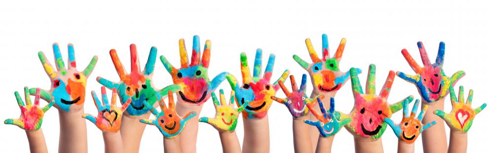 Children's hands waving with colourful smiley faces painted on them